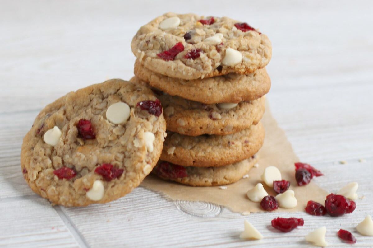 A stack of Oatmeal Cranberry White Chunk Wooden Spoon cookies.